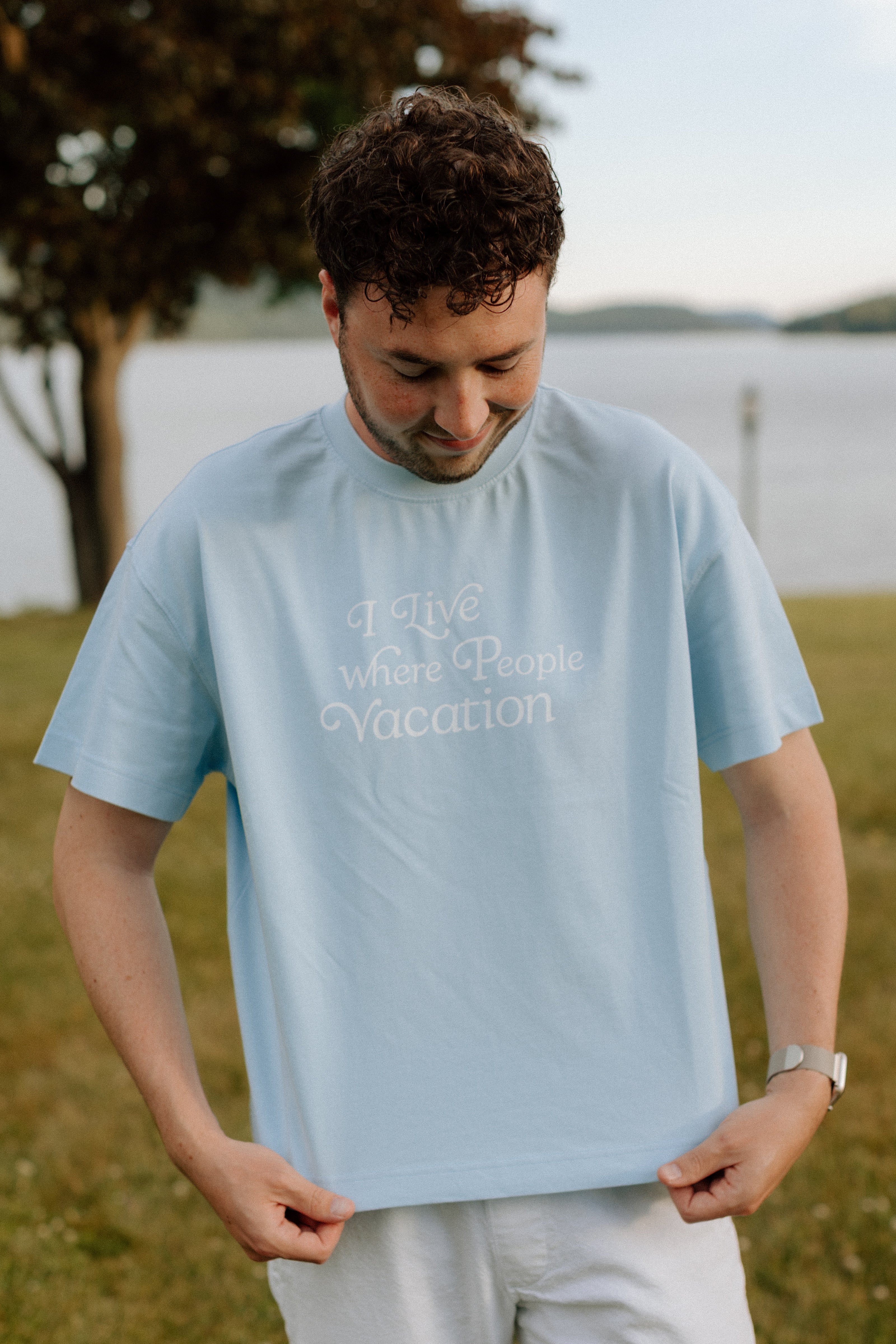 I Live Where People Vacation – Core Tee (Sky Blue Edition)