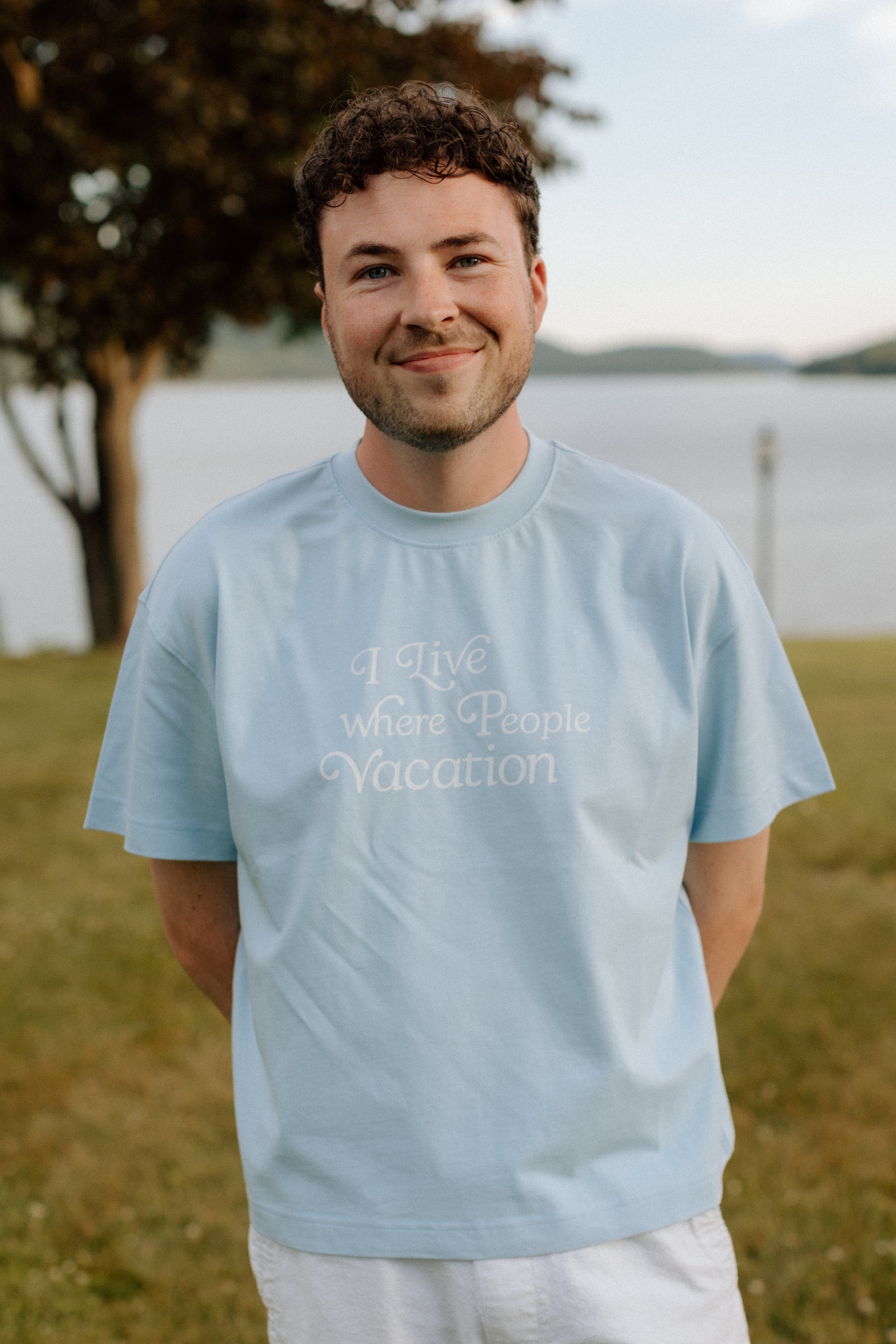 I Live Where People Vacation – Core Tee (Sky Blue Edition)