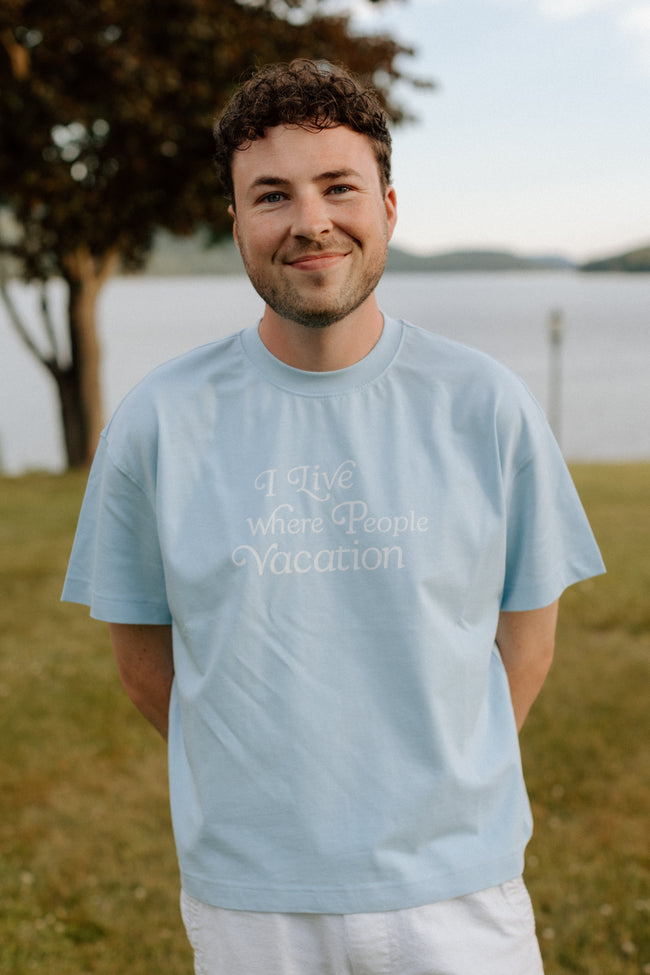 I Live Where People Vacation – Core Tee (Sky Blue Edition)